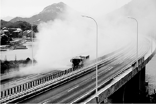 2月10日清晨，为保障舟山跨海大桥尽早畅通，浙江交工高等级公路养护有限公司的除雪车、撒盐车在桥上除雪。 姚峰 申军 刘志永 摄 