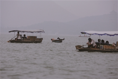 2006年9月3日，杭州西湖，游客仰面朝天躺在小舟上，随波漂荡，享受闲暇时光。 这张照片是当年出差来杭州拍的，当天我就投给都市快报“每天最有意思的照片”栏目，后来居然登了半个版（详见2006年9月6日7版）。 