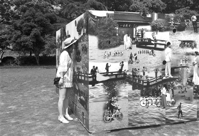 孤山草坪展区，观展者透过杭州时光影像装置上的小孔，观看杭州老照片。 记者 王恒婷 摄