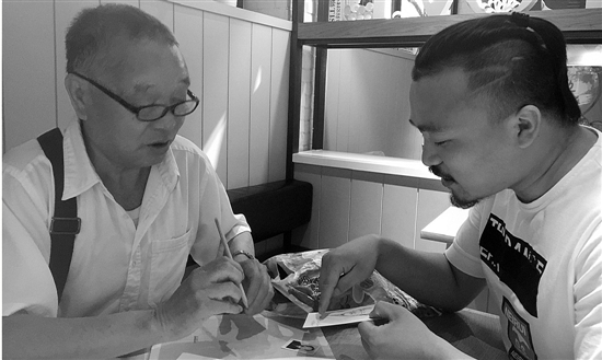 专业美术老师贾艺鹏在帮周善通老人画《父亲》。