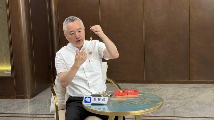 朱军岷就“小老鼠”造型饰品进行说明 记者 黄伟芬 摄